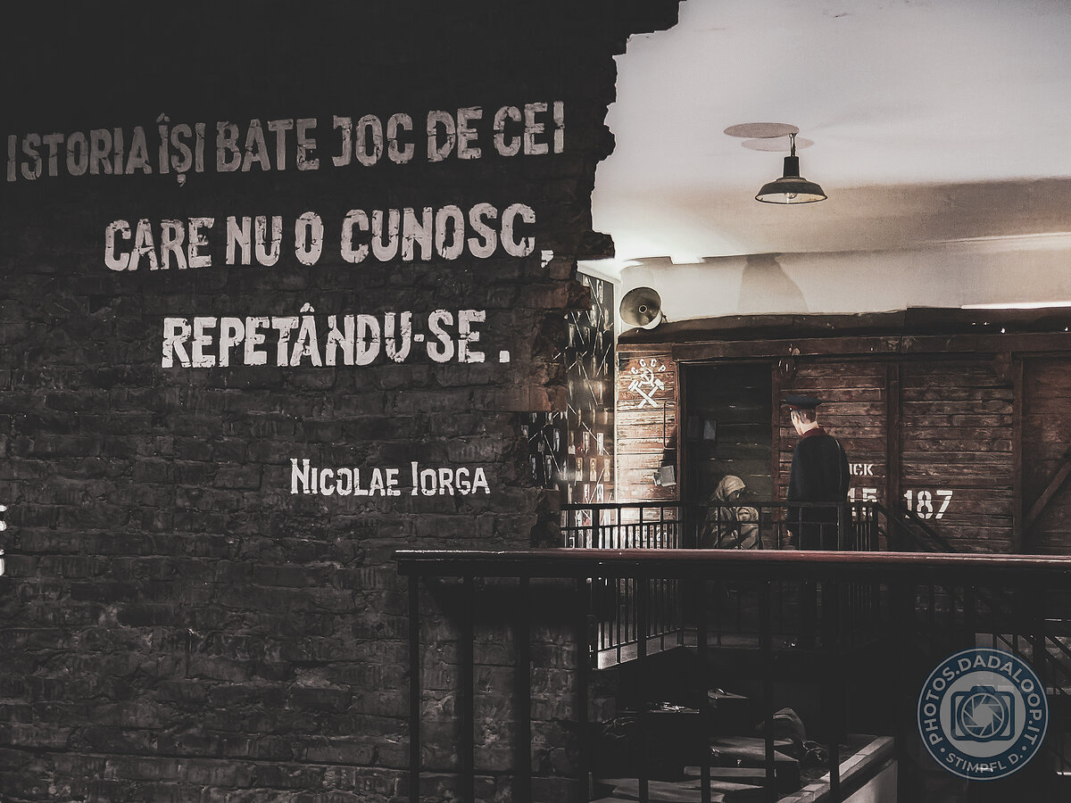 Historical memory: freight car and quote on brick wall