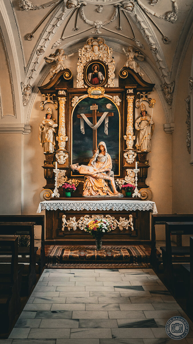 Baroque altar with Pietà sculpture in a historic church interior
