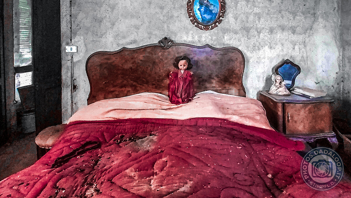 Lonely doll on an abandoned bed