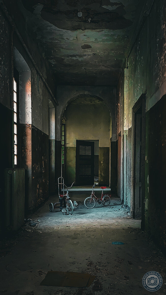Abandoned bicycles in a decaying corridor