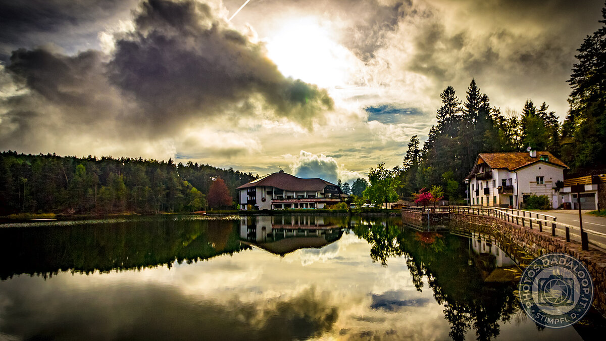 Reflections of architecture and cloudy sky on the lake